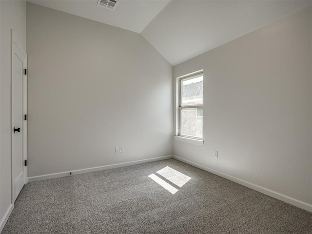 unfurnished room with carpet floors and lofted ceiling