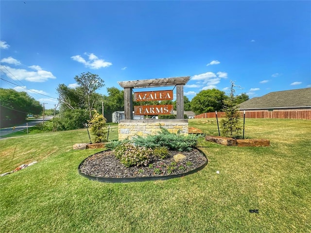 community sign featuring a lawn