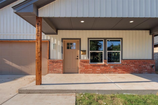 entrance to property with covered porch and a garage