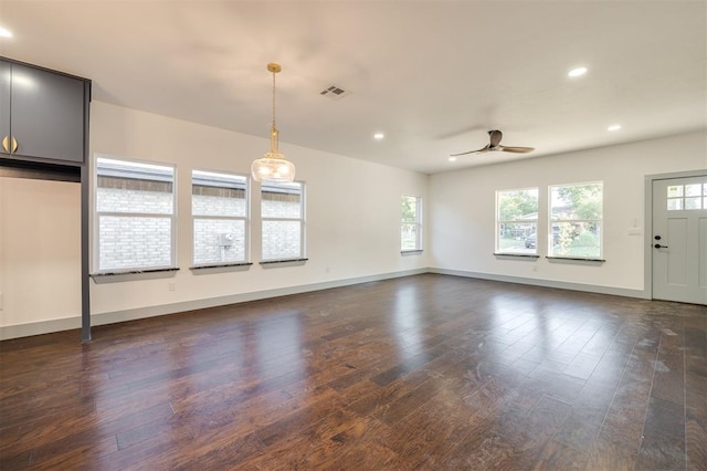 interior space with dark hardwood / wood-style floors, a wealth of natural light, and ceiling fan