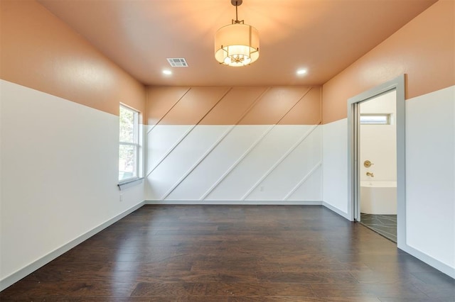 empty room with dark wood-type flooring