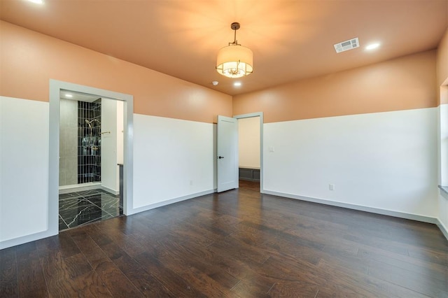 spare room with dark hardwood / wood-style flooring