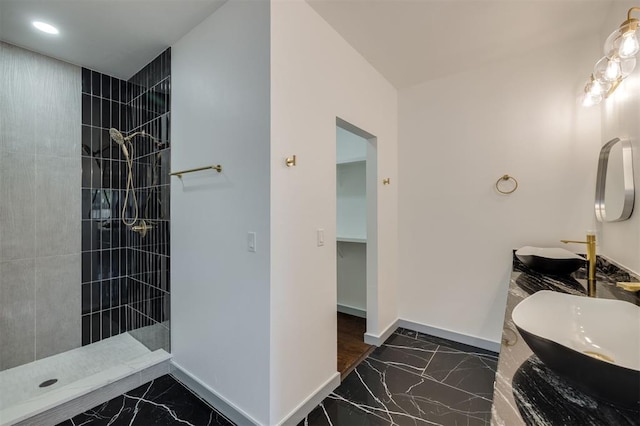 bathroom featuring vanity and a tile shower