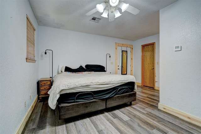 bedroom featuring ceiling fan and hardwood / wood-style floors