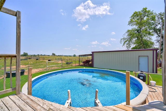 view of pool with a rural view and a wooden deck