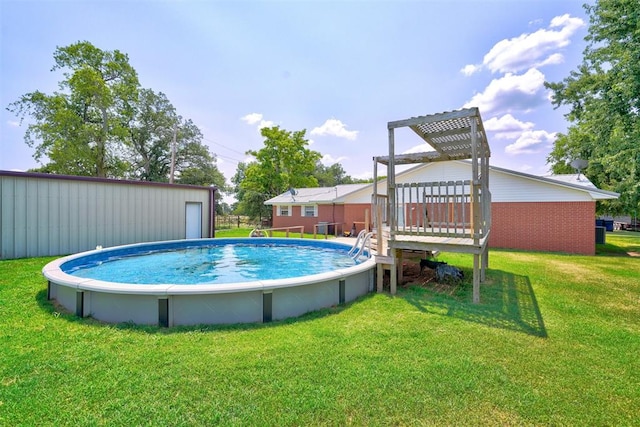 view of pool featuring a deck and a lawn