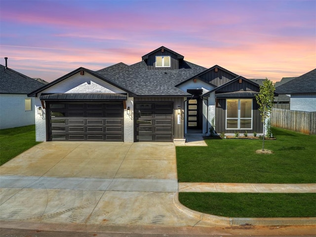 view of front of house with a garage and a yard