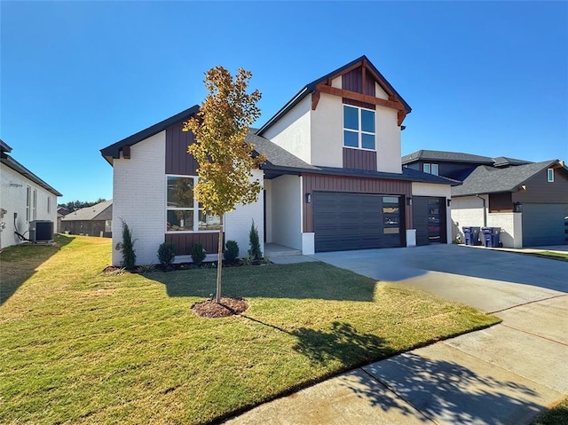 view of front of house featuring a front lawn, a garage, and central AC unit