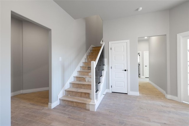 stairway with hardwood / wood-style flooring