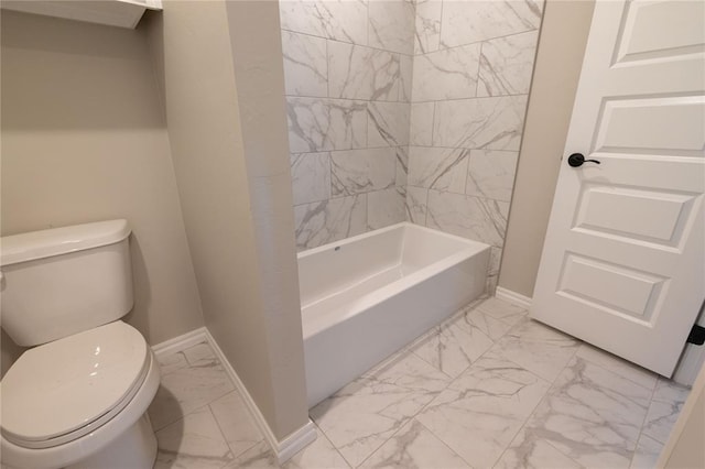 bathroom with tiled shower / bath combo and toilet