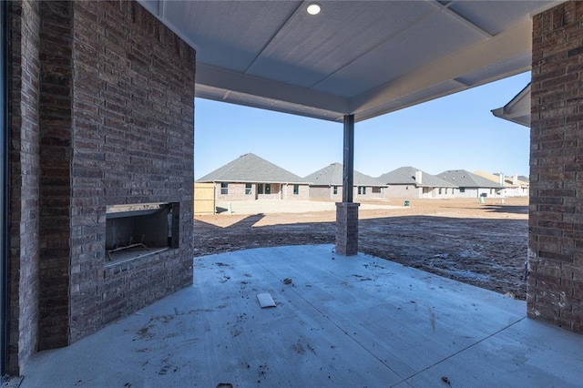 view of patio / terrace with an outdoor brick fireplace