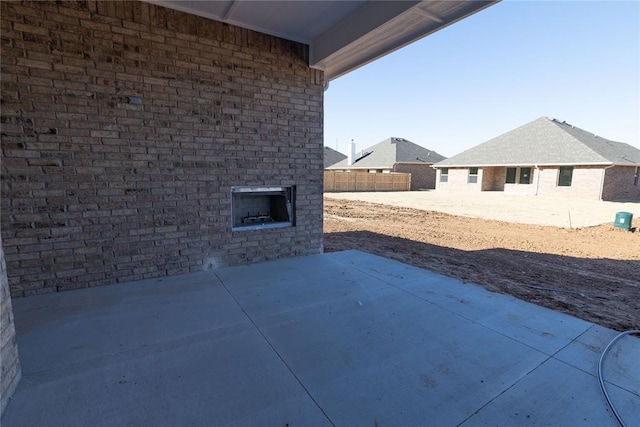 view of patio featuring an outdoor brick fireplace