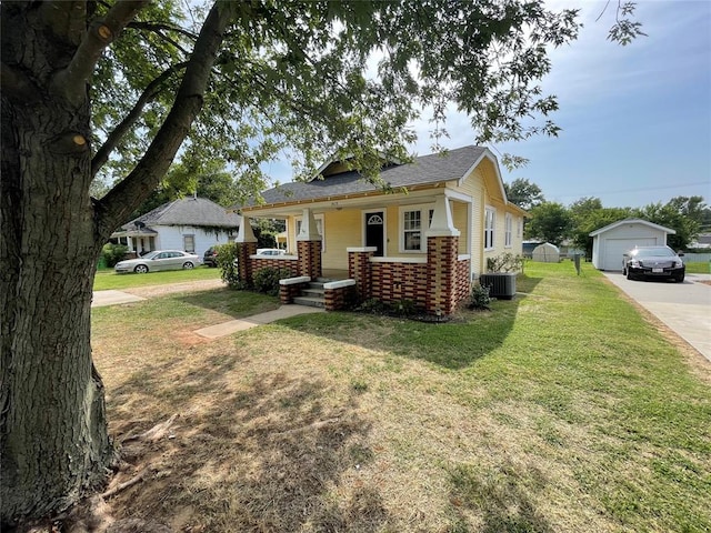 view of front of house with central AC unit, a garage, an outdoor structure, and a front yard