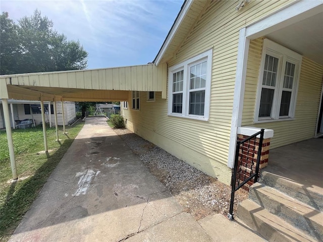 view of side of property with a carport