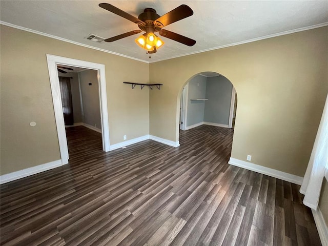 empty room featuring dark hardwood / wood-style flooring, ceiling fan, and crown molding