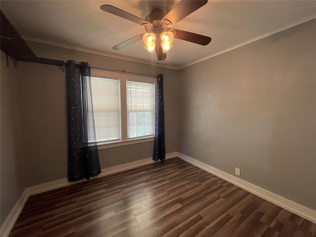 spare room featuring ceiling fan, dark wood-type flooring, and ornamental molding