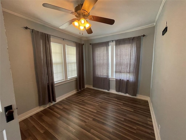 unfurnished room featuring ornamental molding, dark wood-type flooring, and a wealth of natural light