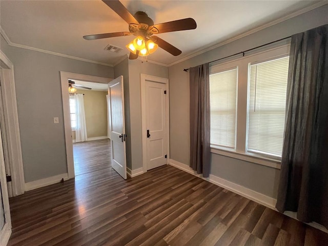 interior space with ceiling fan, dark hardwood / wood-style floors, and ornamental molding