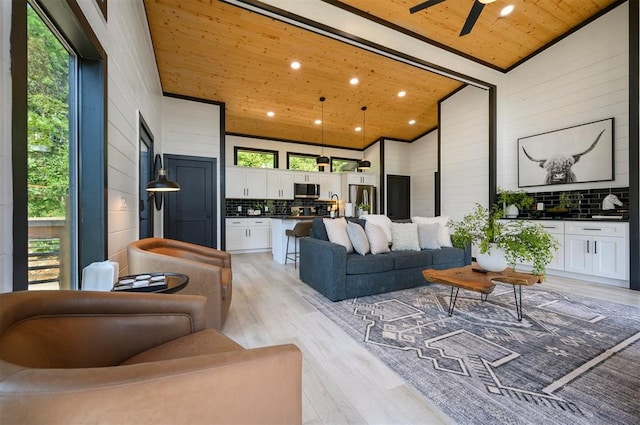 living room featuring high vaulted ceiling, wood ceiling, and a wealth of natural light