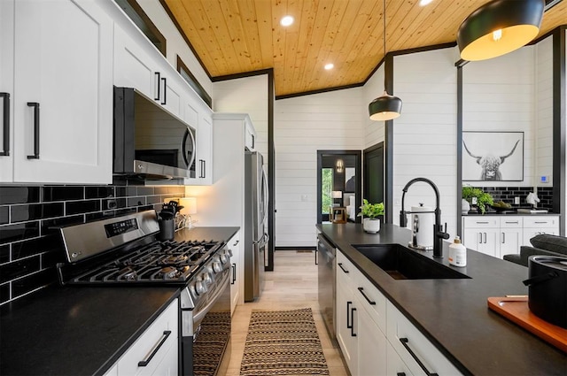 kitchen featuring appliances with stainless steel finishes, sink, pendant lighting, wooden ceiling, and lofted ceiling