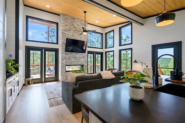 dining room with plenty of natural light, light hardwood / wood-style floors, and wooden ceiling