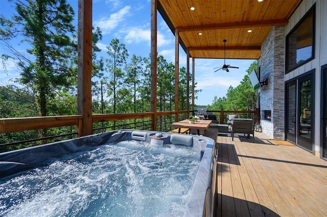 deck with ceiling fan and an outdoor hot tub