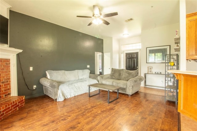 living room with a fireplace, hardwood / wood-style flooring, and ceiling fan