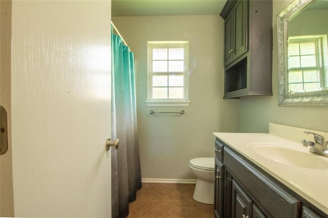 bathroom featuring a shower with shower curtain, tile patterned floors, vanity, and toilet