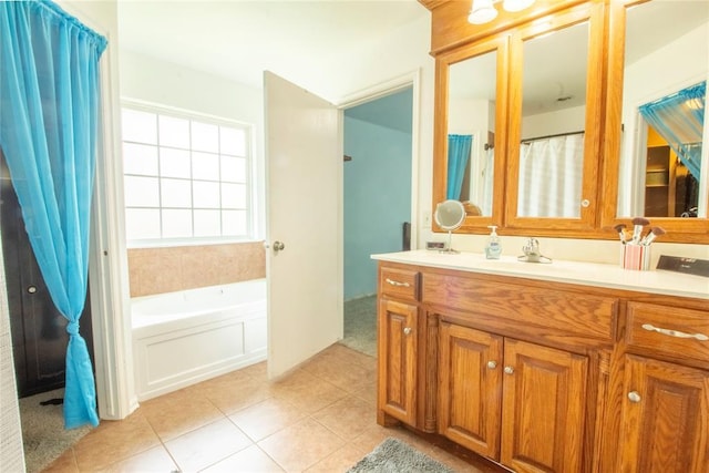 bathroom with tile patterned floors, vanity, and a tub to relax in