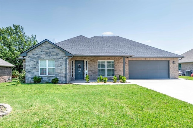 view of front of property with a front yard and a garage