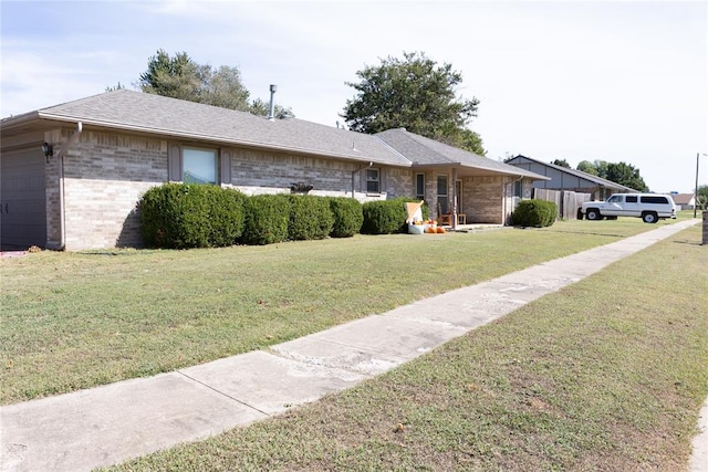 single story home featuring a front lawn and a garage