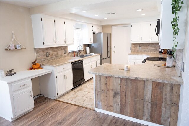 kitchen with sink, stainless steel fridge, light wood-type flooring, black dishwasher, and white cabinetry