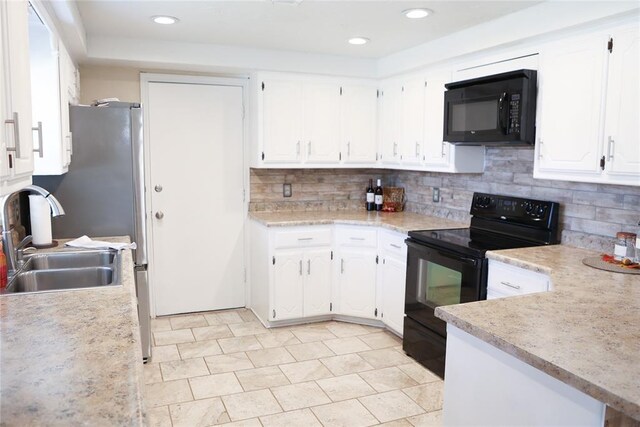 kitchen with black appliances, white cabinets, sink, and tasteful backsplash