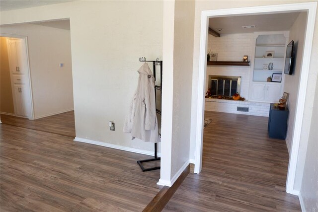 corridor with dark hardwood / wood-style flooring