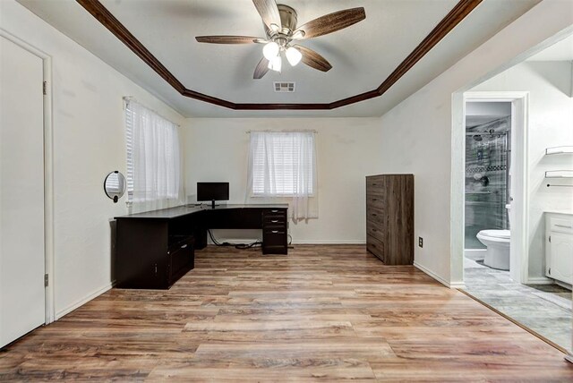 home office featuring a tray ceiling, light hardwood / wood-style flooring, ceiling fan, and crown molding