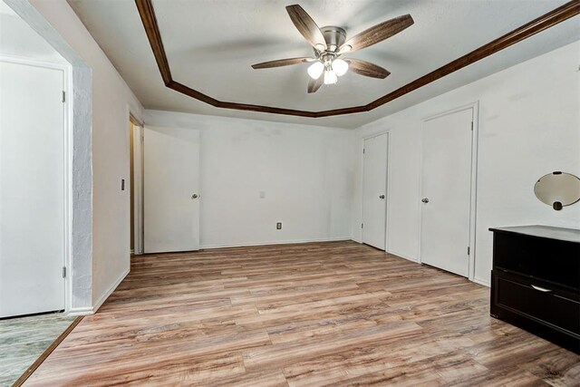 unfurnished bedroom with light hardwood / wood-style flooring and ceiling fan