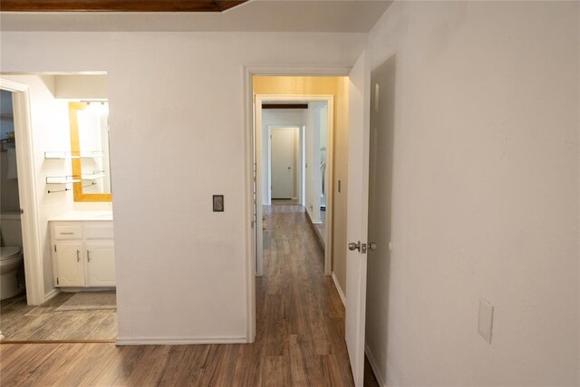 corridor featuring wood-type flooring