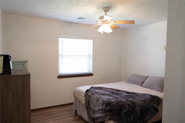 bedroom with ceiling fan and wood-type flooring