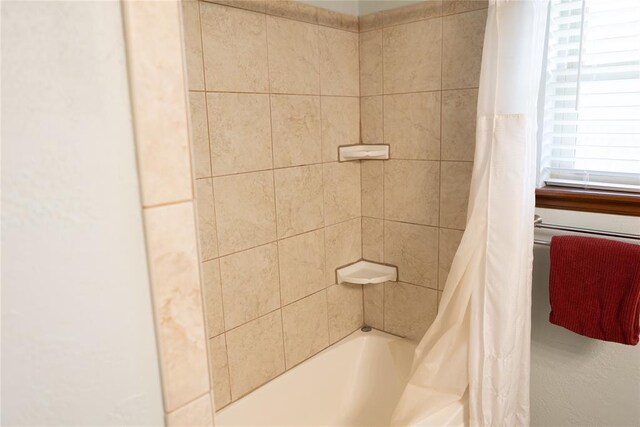 bathroom featuring shower / bath combo with shower curtain