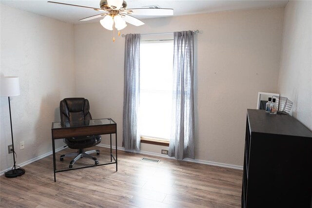 office with ceiling fan and light hardwood / wood-style flooring