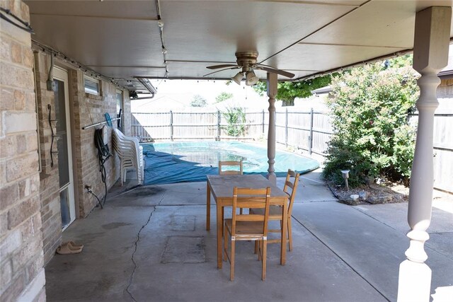 view of patio with ceiling fan and a fenced in pool