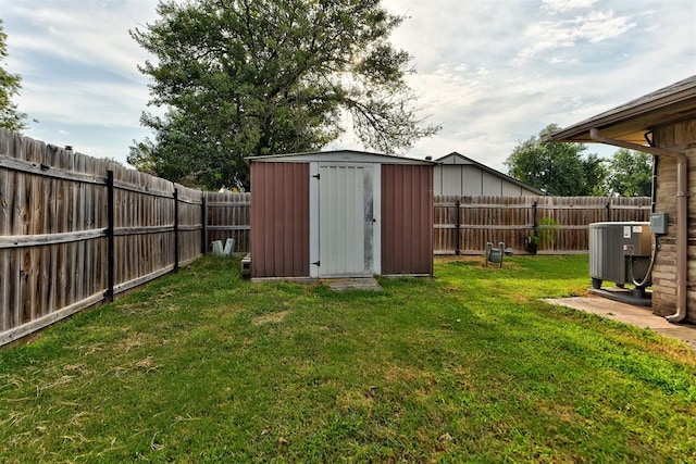 view of outdoor structure featuring central air condition unit and a yard