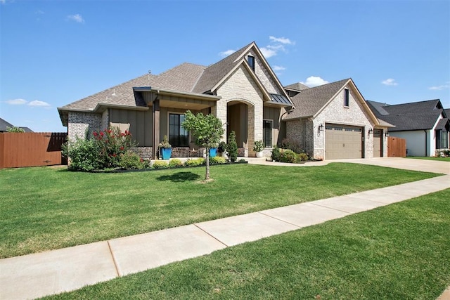 view of front of property with a garage and a front lawn