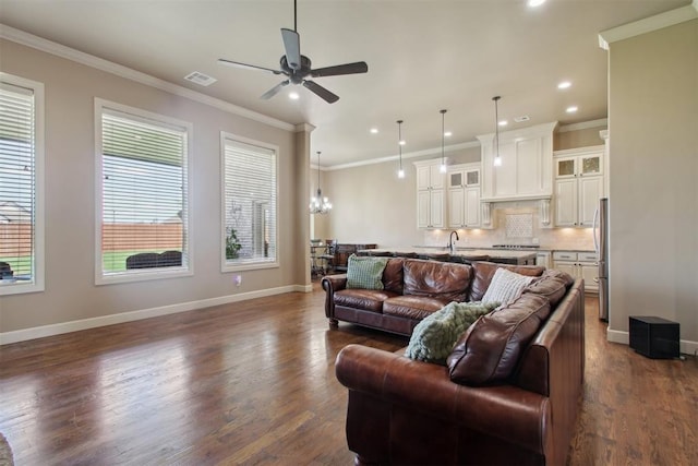 living room featuring sink, dark hardwood / wood-style flooring, ceiling fan with notable chandelier, and ornamental molding