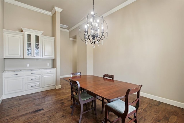 dining area featuring dark wood-type flooring, a notable chandelier, and ornamental molding