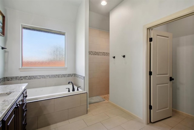 bathroom with tile patterned floors, vanity, and separate shower and tub