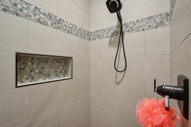 bathroom with tiled shower