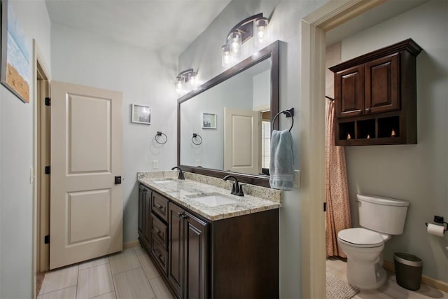 bathroom with tile patterned floors, vanity, and toilet