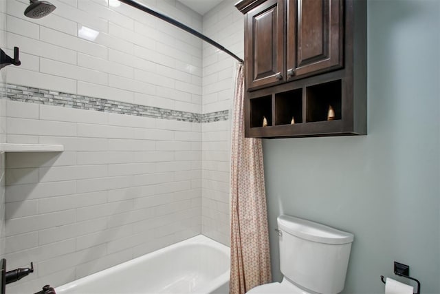 bathroom featuring shower / bath combo and toilet