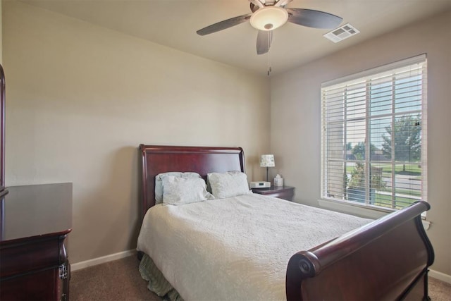 carpeted bedroom featuring multiple windows and ceiling fan